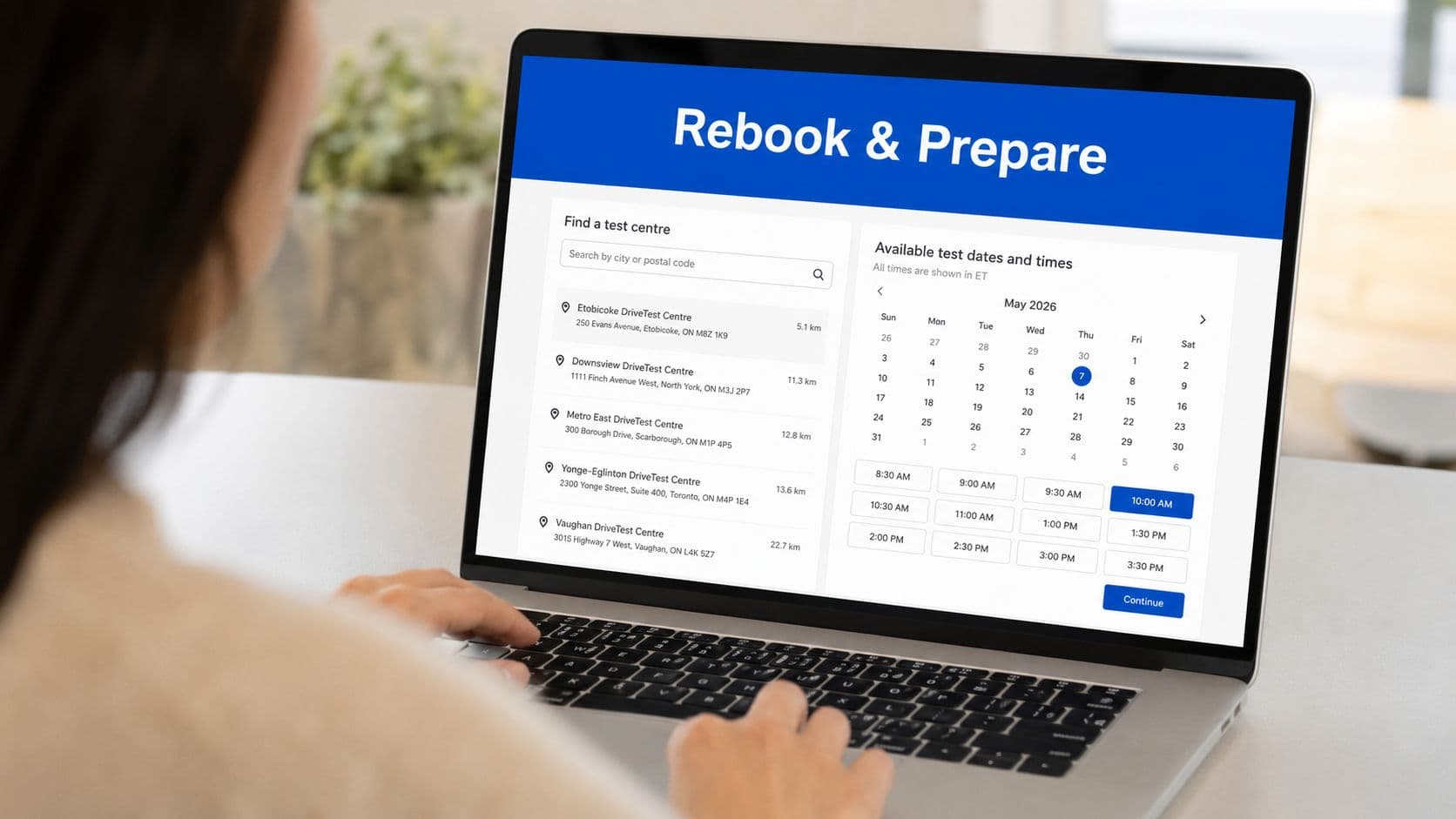 A person using a laptop to rebook an Ontario driving test appointment on an online scheduling website.