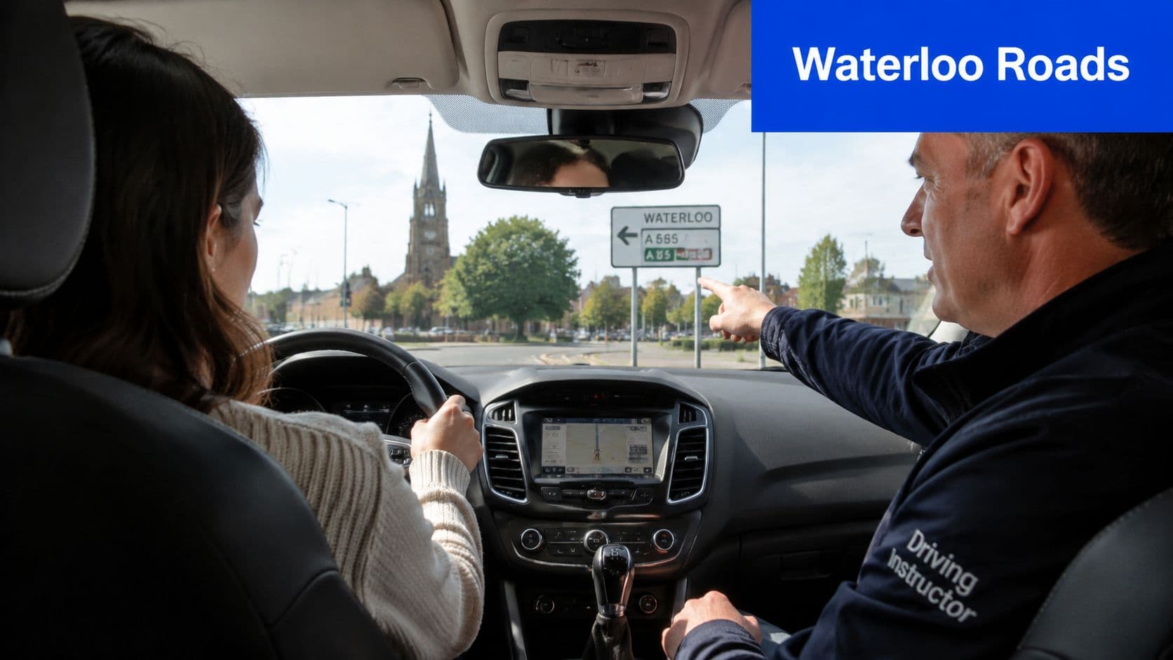 A driving instructor pointing to a road sign while giving a lesson to a female student.